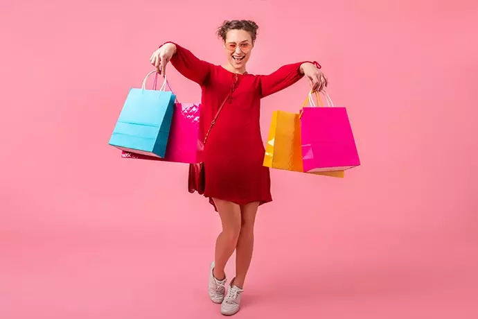 woman in red dress holding shopping bags