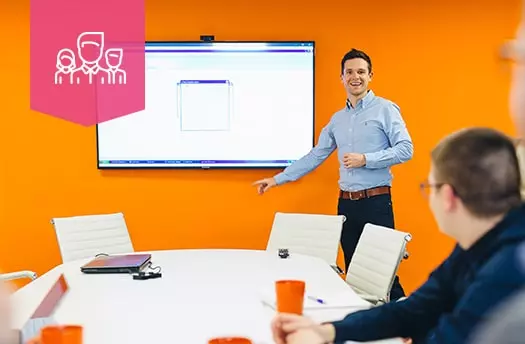 man presenting information to room of people