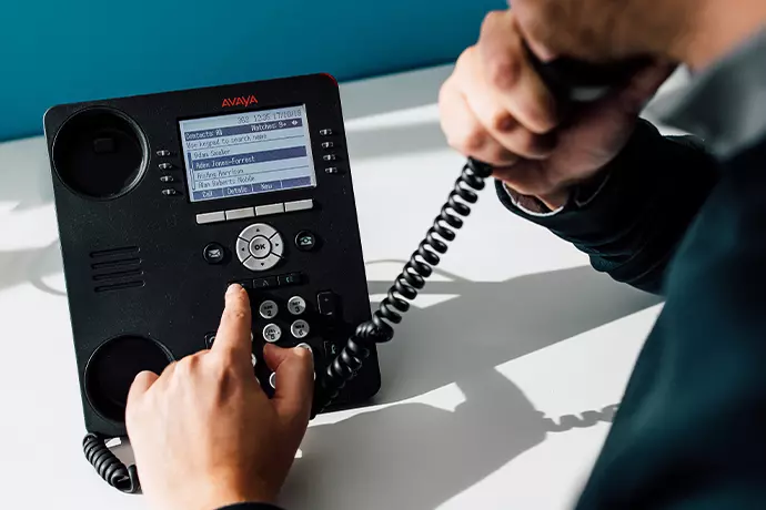 Close up of an Avaya office telephone in use