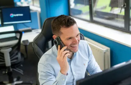 IT Support Sales Director Smiling on the phone