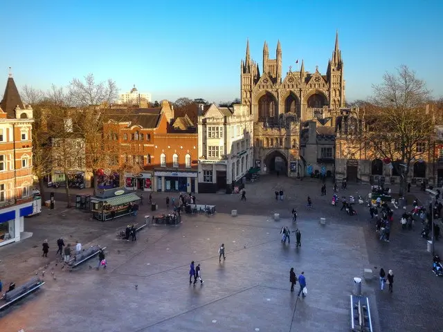 An open shot ofCathedral Square in Peterborough with people walking through